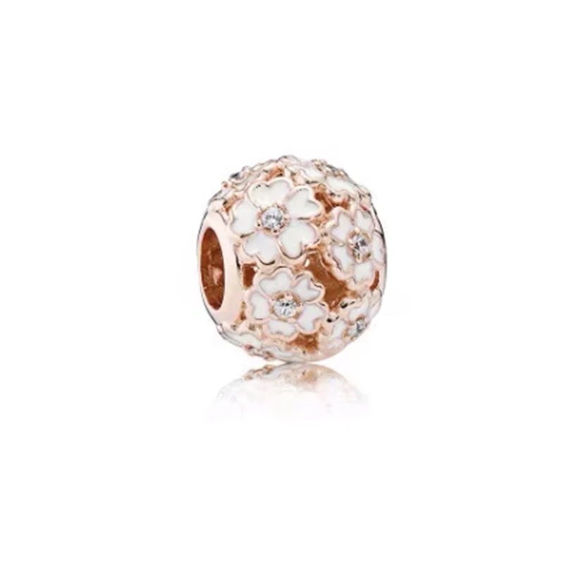 Rose gold charm with white flower and diamonds