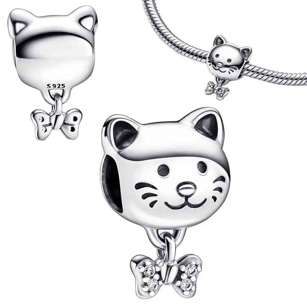 Sterling silver cat face charm with dangling bow, fits Pandora bracelet.