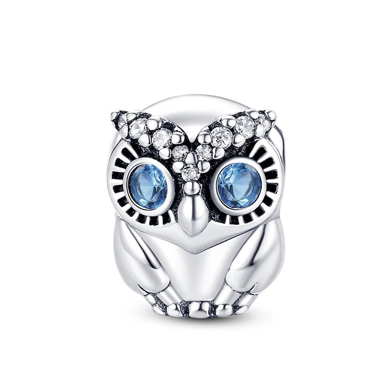 Sterling silver owl charm with blue eyes and crystal accents.