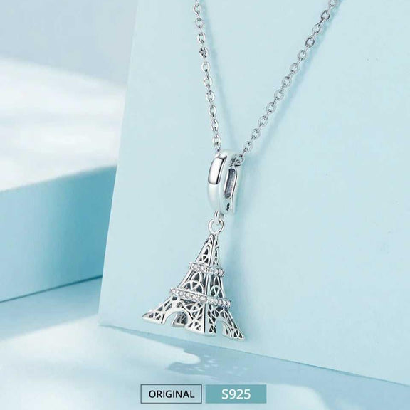 Sterling Silver Eiffel Tower Charm with Rhinestone Bands - Sterling silver Eiffel Tower pendant necklace displayed on a light blue background.