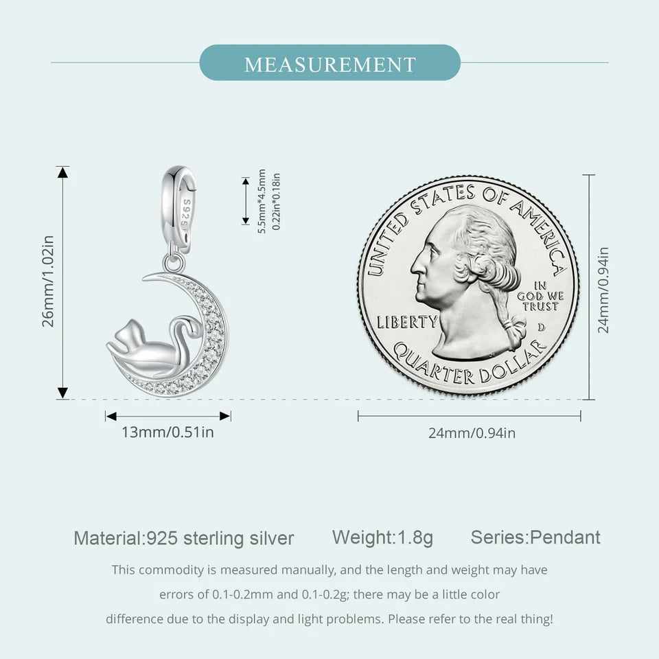 Measurement details of a sterling silver cat on crescent moon charm with a quarter coin for size reference, showing a height of 26mm and a width of 13mm.