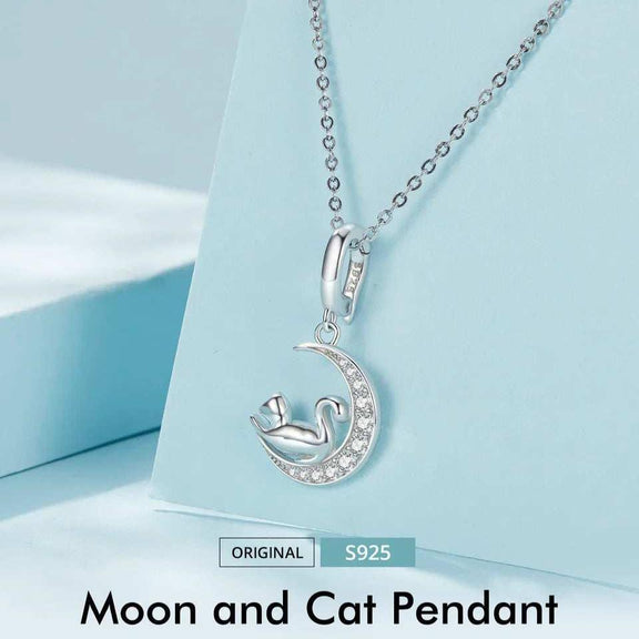 Sterling Silver Cat on Crescent Moon Charm with Rhinestones - Sterling silver moon and cat pendant necklace displayed on a light blue background.