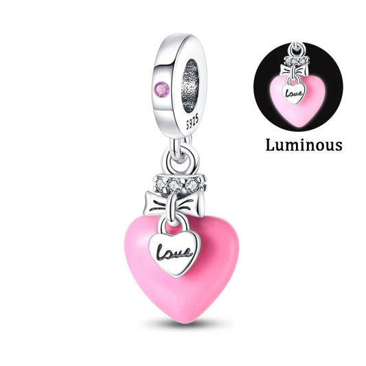 Luminous sterling silver pink heart charm with love tag.