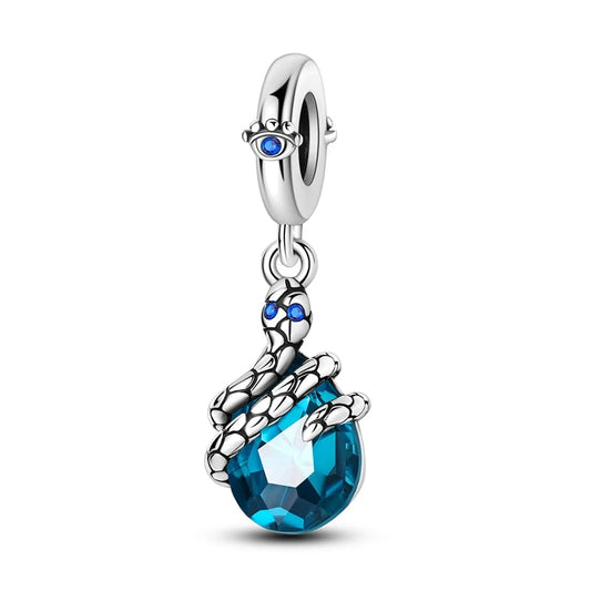 Sterling silver charm with a blue crystal held by a dragon claw.