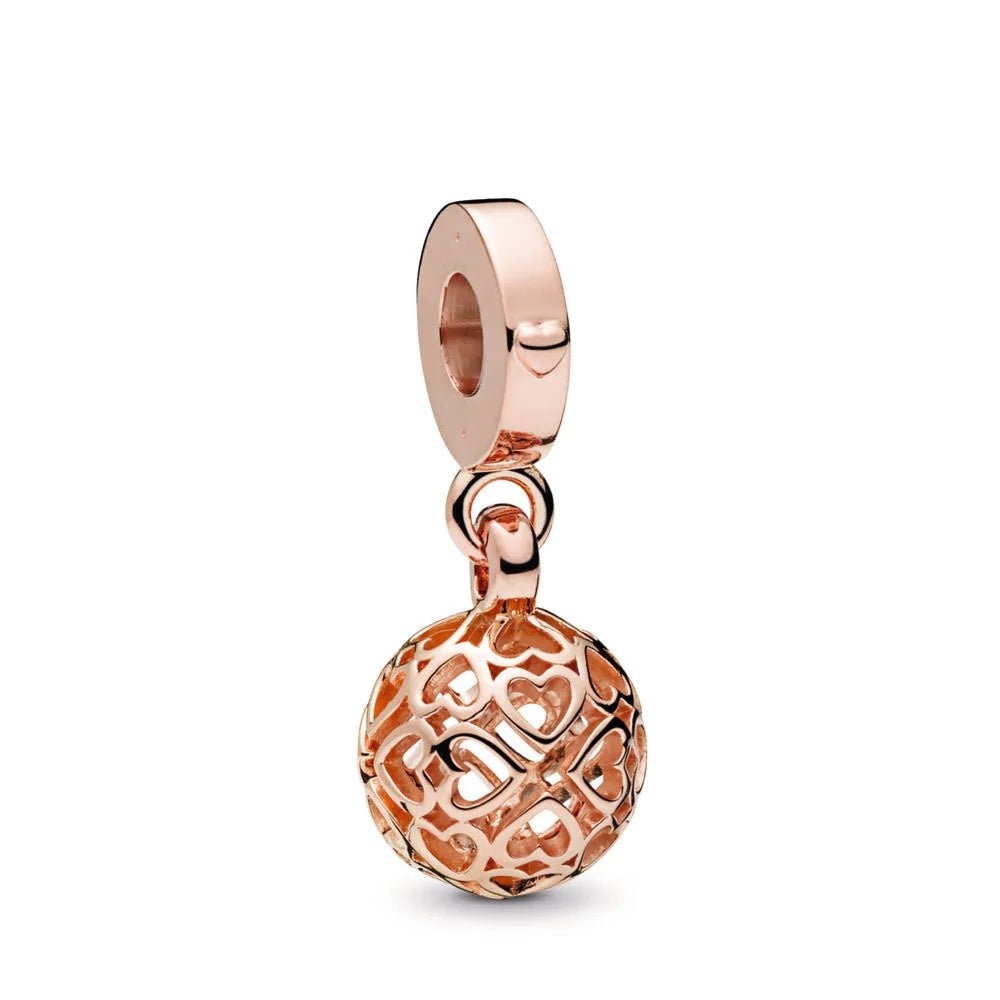 Rose gold charm with intricate heart filigree design, perfect for charm bracelets, necklaces,.