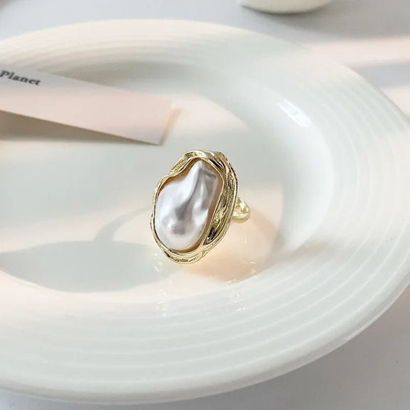 Adjustable Gold Ring with Unique Baroque Pearl - Back view of a gold ring with a baroque pearl centerpiece, highlighting the ring's band and intricate detailing.