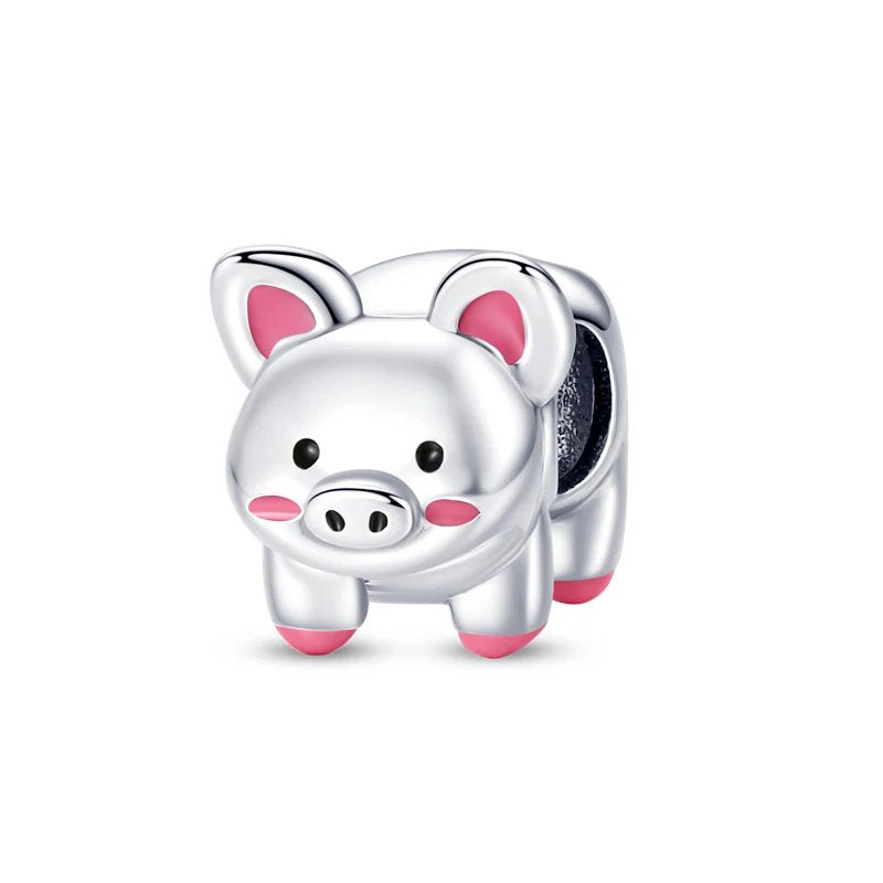 Sterling silver pig charm with pink accents.