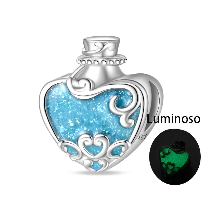 Sterling silver heart potion bottle charm with luminous blue enamel that glows in the dark.