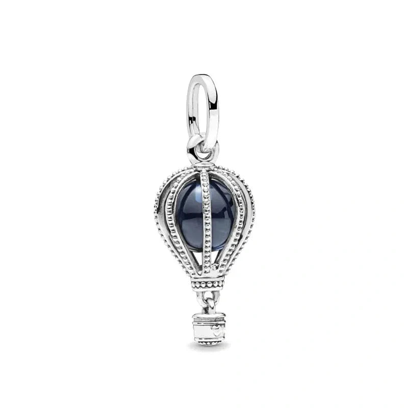 Sterling silver hot air balloon charm with sapphire stone and detailed basket design.