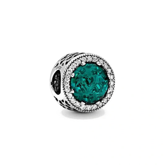 Sterling silver charm with emerald green crystal and diamond-like cubic zirconia halo.