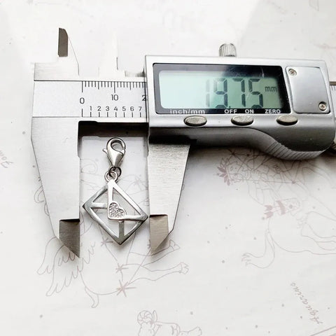 Silver envelope charm with heart.