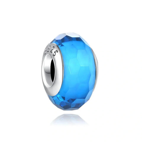 Sterling silver charm with faceted blue crystal for a vibrant and elegant look.