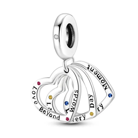 Sterling silver charm with interlocking hearts and multicolored cubic zirconia.