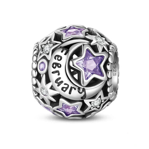 Silver charm with purple stars and moon.