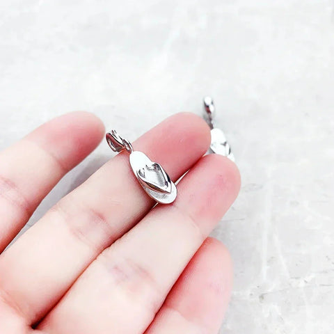Silver flip-flop pendant.