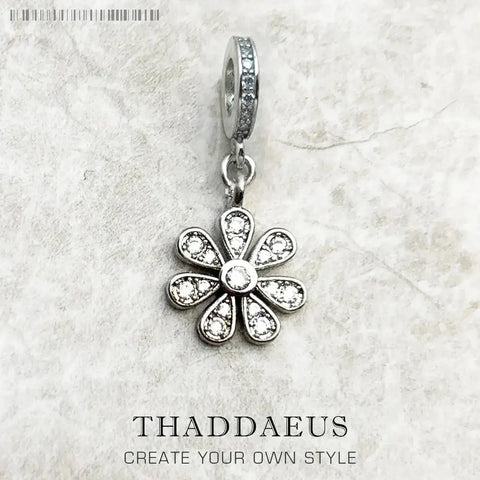Silver flower charm with clear stones.