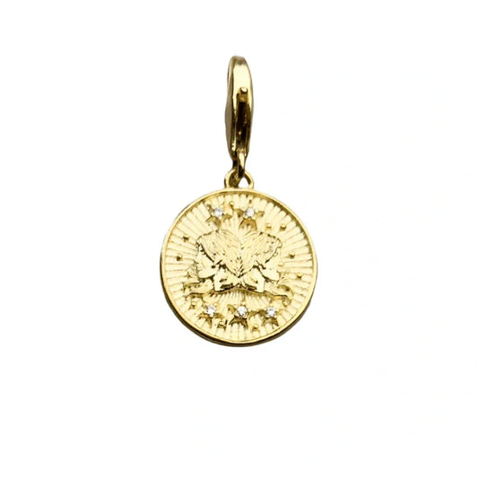 Gold coin pendant with gem accents.