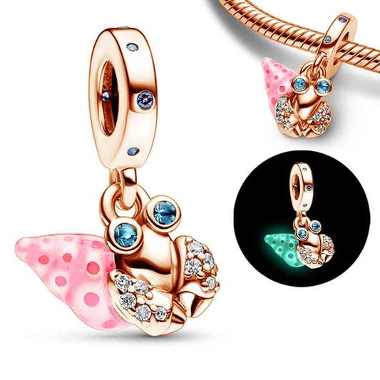 Glow in the Dark Snail Charm in rose gold with crystal details and a glow-in-the-dark shell. A fun and unique addition to any jewelry collection.