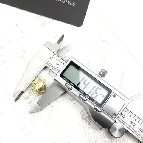 Golden nugget measured by calipers.