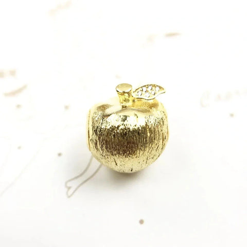 Golden apple charm.