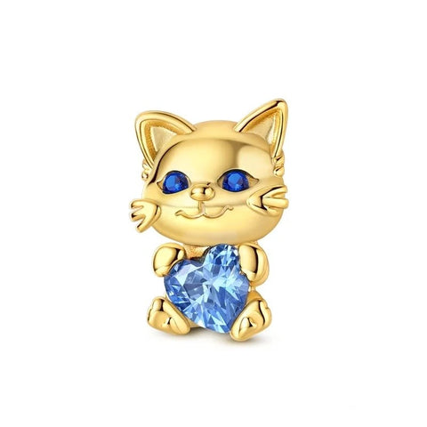 Gold Cat Holding Blue Heart Crystal Charm - A gold-tone cat charm with blue crystal eyes holding a faceted light-blue heart-shaped crystal, designed as a clip-on charm for charm bracelets
