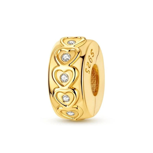 A gold-tone barrel-shaped clip charm featuring open heart cutouts with clear crystal centres encircling the band, with S925 stamped on the side