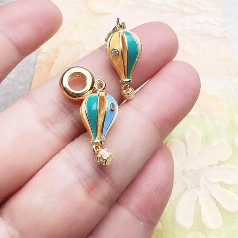 Two gold hot air balloon charms.