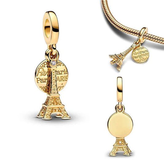 Golden Eiffel Tower charm with an engraved Paris coin and crystal accent, perfect for lovers of travel and French elegance.