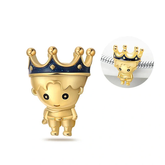 Golden prince charm with blue enamel crown, perfect for fairy tale lovers and jewelry enthusiasts seeking a regal touch.