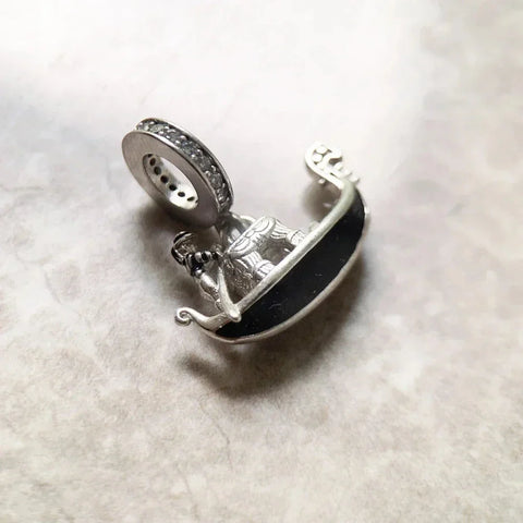 Silver gondola charm with black enamel and rhinestone-studded bail.
