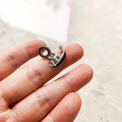 Silver gondola charm.