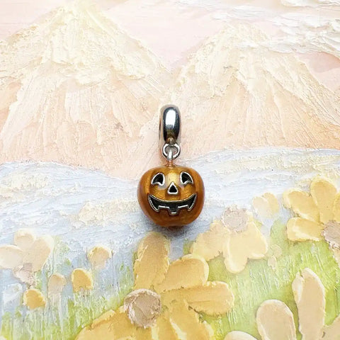 Pumpkin charm with silver bail.