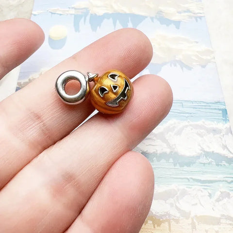 Orange jack-o?-lantern charm.