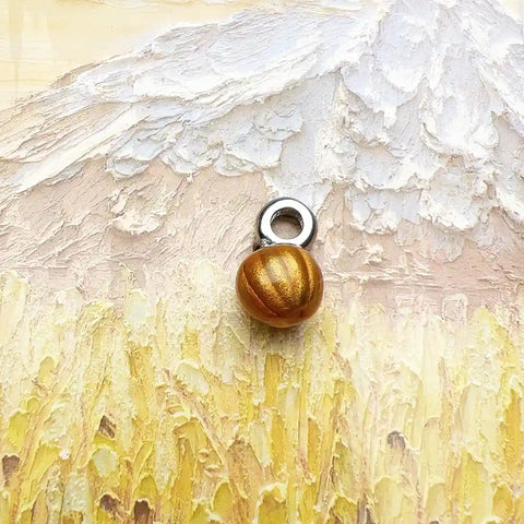 Golden pumpkin charm.
