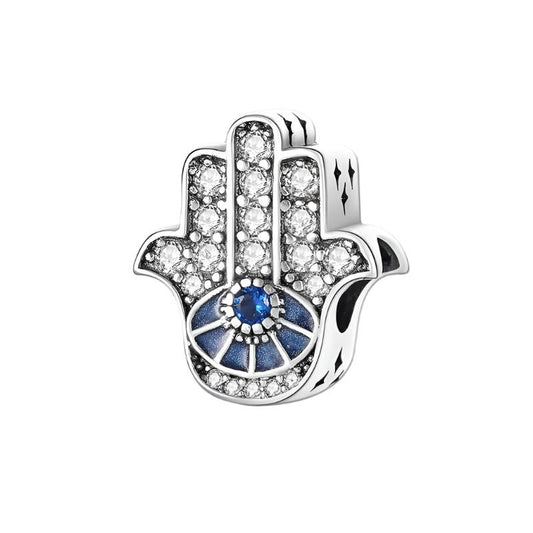 Sterling silver hand charm with a blue central gem and sparkling crystals, ideal for charm bracelets or necklaces.