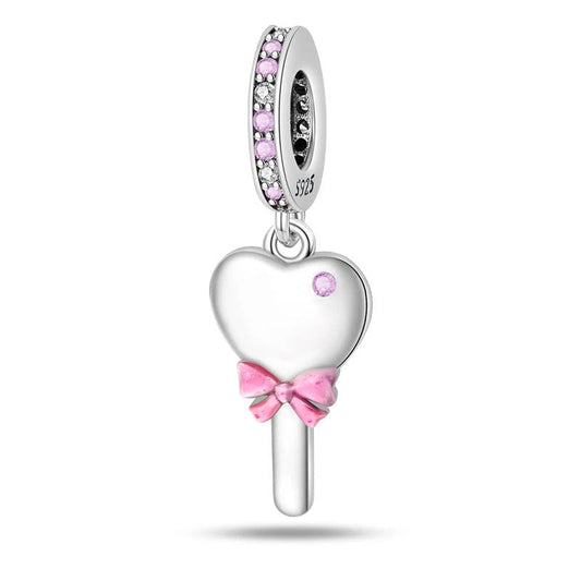 A sterling silver heart-shaped mirror charm with pink enamel and a bow, accented by zirconia stones, perfect for playful styles.