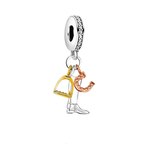 Silver charm with gold stirrup, rose gold horseshoe, and silver boot.