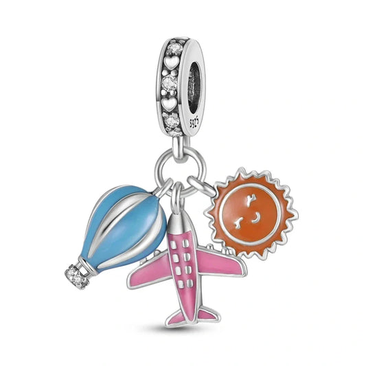 Sterling silver charm with a blue hot air balloon, pink airplane, and orange sun, perfect for travel lovers.