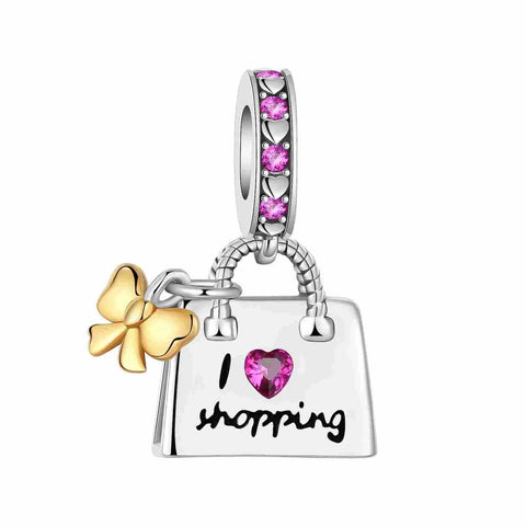 I Love Shopping Bag Charm Pink Crystal and Golden Bow for Bracelets - Sterling silver shopping bag charm with pink crystals and golden bow, featuring I love shopping script.