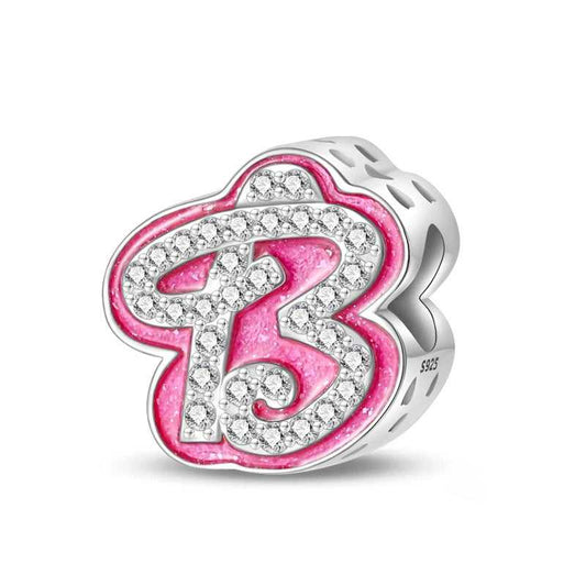 A sterling silver "B" initial charm with pink enamel and sparkling zirconia accents, perfect for personalized jewelry.