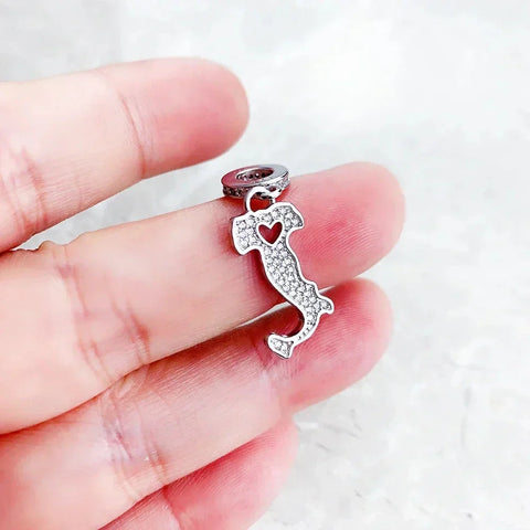 Italy-shaped charm with heart cutout.