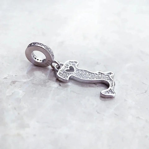 Silver Italy-shaped charm with embedded crystals.