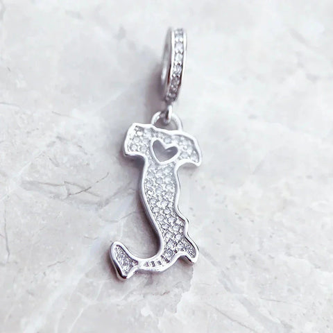 Silver Italy-shaped charm with heart cutout.