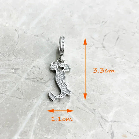 Italy-shaped charm with embedded crystals.