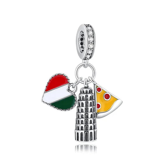 A silver-tone clip-on charm with three pendants: an oxidised Leaning Tower of Pisa, a yellow enamel pizza slice with red toppings, and a heart charm in red, white, and green Italian flag colours, hanging from a crystal-studded bale.