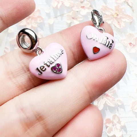 Pink heart-shaped charm pendants.