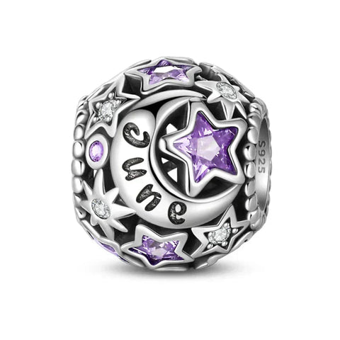 Silver charm with purple stars and moon.