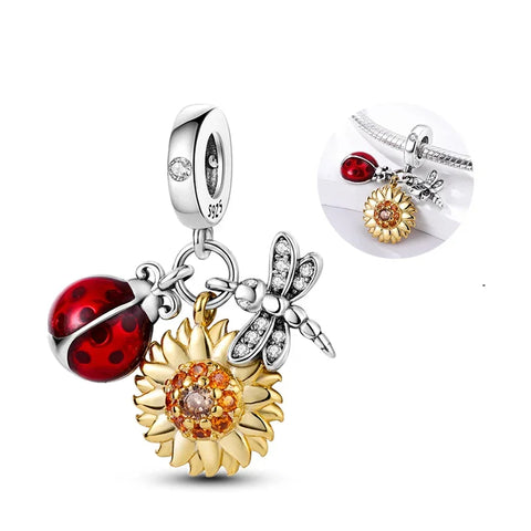 Trio charm with ladybug, dragonfly, and sunflower in sterling silver, featuring colorful enamel and crystal details.