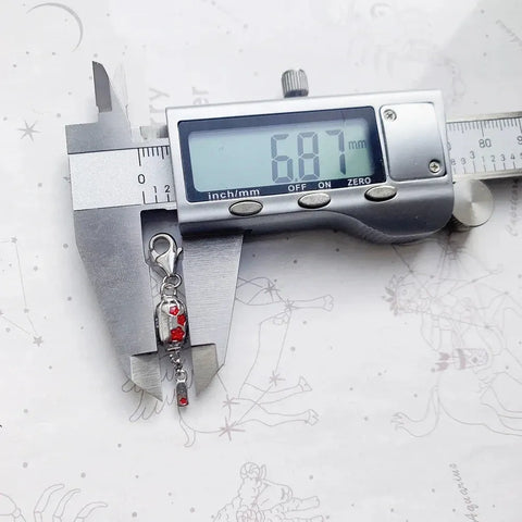 Silver charm being measured.