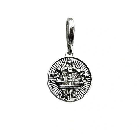 Silver-colored scales of justice pendant.